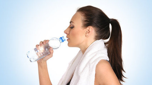 Kobieta pijąca wodę z butelki